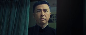 Movie still from “Ip Man 4: The Finale” (2019), directed by Wilson Yip – A person wearing a black shirt; Close Up shot, Low angle