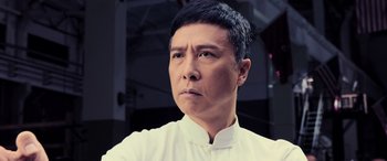 Movie still from “Ip Man 4: The Finale” (2019), directed by Wilson Yip – A person wearing a white shirt; Close Up shot, Low angle