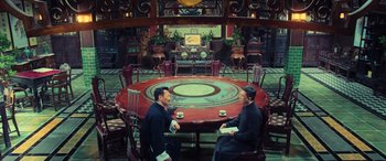 Movie still from “Ip Man 4: The Finale” (2019), directed by Wilson Yip – Two men sitting at a round table in an oriental restaurant; Wide shot, High angle