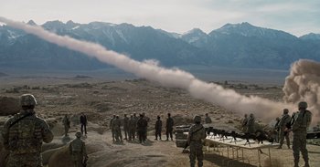 Movie still from “Iron Man” (2008), directed by Jon Favreau – A group of soldiers standing on top of a hill; Extreme Wide shot, High angle