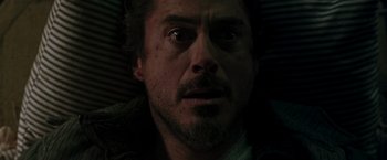 Movie still from “Iron Man” (2008), directed by Jon Favreau – A person looking at the camera; Close Up shot, Overhead angle