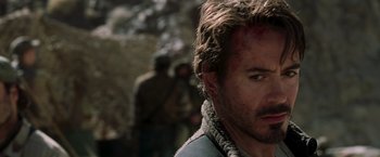 Movie still from “Iron Man” (2008), directed by Jon Favreau – A person wearing a jacket; Close Up shot, Over the shoulder angle