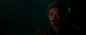 Movie still from “Iron Man” (2008), directed by Jon Favreau – A person wearing a hat; Close Up shot, Over the shoulder angle