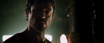 Movie still from “Iron Man” (2008), directed by Jon Favreau – A person with a beard; Close Up shot, Low angle