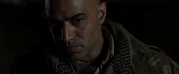 Movie still from “Iron Man” (2008), directed by Jon Favreau – A man with a bald head is looking at the camera; Close Up shot, Over the shoulder angle