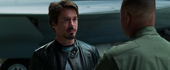 Movie still from “Iron Man” (2008), directed by Jon Favreau – A man in a leather jacket talking to another man in a leather jacket; Close Up shot, Over the shoulder angle