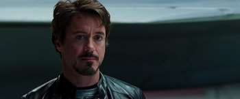 Movie still from “Iron Man” (2008), directed by Jon Favreau – A person wearing a leather jacket; Close Up shot, Over the shoulder angle