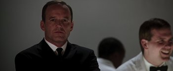 Movie still from “Iron Man” (2008), directed by Jon Favreau – A man in a black suit and a white tie; Close Up shot, Low angle