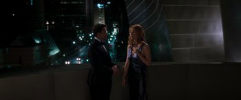 Movie still from “Iron Man” (2008), directed by Jon Favreau – A man and a woman standing next to each other; Medium shot, High angle