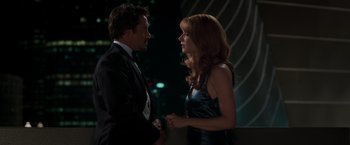 Movie still from “Iron Man” (2008), directed by Jon Favreau – A man and a woman are talking to each other; Medium shot, Low angle