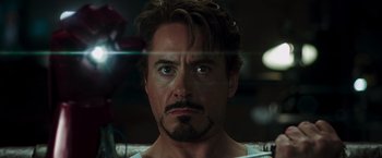 Movie still from “Iron Man” (2008), directed by Jon Favreau – A person with a beard; Close Up shot, Over the shoulder angle