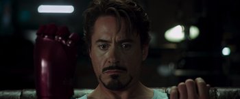 Movie still from “Iron Man” (2008), directed by Jon Favreau – A person with a beard; Close Up shot, Over the shoulder angle