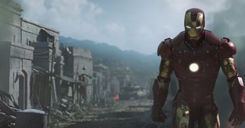 Movie still from “Iron Man” (2008), directed by Jon Favreau – A man standing in front of an abandoned town; Medium shot, Low angle