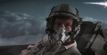 Movie still from “Iron Man” (2008), directed by Jon Favreau – A man in a fighter pilot's helmet and mask; Close Up shot, Low angle