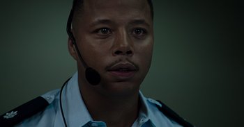 Movie still from “Iron Man” (2008), directed by Jon Favreau – A person wearing a headset; Close Up shot, Low angle