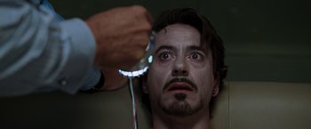 Movie still from “Iron Man” (2008), directed by Jon Favreau – A man is getting his face waxed by a barber; Close Up shot, Over the shoulder angle