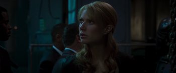 Movie still from “Iron Man” (2008), directed by Jon Favreau – A woman with long blonde hair looking to her left; Close Up shot, Low angle