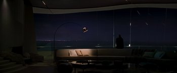 Movie still from “Iron Man” (2008), directed by Jon Favreau – A living room with a couch and a lamp in the corner of the room; Extreme Wide shot, High angle