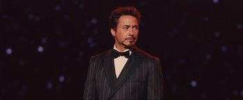 Movie still from “Iron Man 2” (2010), directed by Jon Favreau – A man in a suit and bow tie; Close Up shot, Low angle