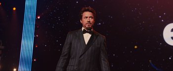 Movie still from “Iron Man 2” (2010), directed by Jon Favreau – A wax statue of a man in a suit and bow tie; Medium shot, Low angle