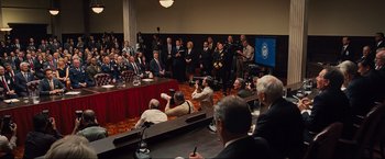 Movie still from “Iron Man 2” (2010), directed by Jon Favreau – A group of people sitting in a conference room; Extreme Wide shot, High angle