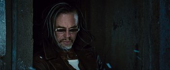 Movie still from “Iron Man 2” (2010), directed by Jon Favreau – A man with long dreadlocks wearing a leather jacket; Close Up shot, Low angle