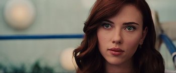 Movie still from “Iron Man 2” (2010), directed by Jon Favreau – A woman with red hair and green eyes; Close Up shot, Over the shoulder angle
