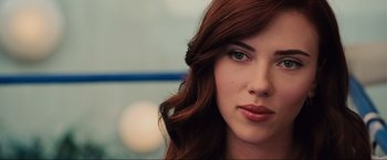 Movie still from “Iron Man 2” (2010), directed by Jon Favreau – A woman with red hair and green eyes; Close Up shot, Over the shoulder angle