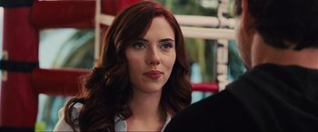 Movie still from “Iron Man 2” (2010), directed by Jon Favreau – A person with long red hair; Close Up shot, Over the shoulder angle