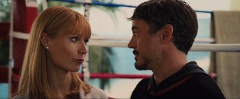 Movie still from “Iron Man 2” (2010), directed by Jon Favreau – A man and a woman staring at each other; Close Up shot, Over the shoulder angle