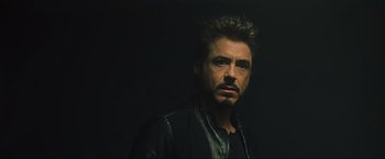 Movie still from “Iron Man 2” (2010), directed by Jon Favreau – A person wearing a leather jacket; Close Up shot, Low angle