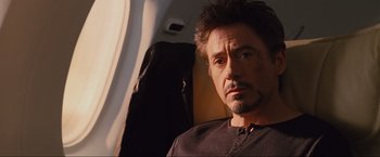 Movie still from “Iron Man 2” (2010), directed by Jon Favreau – A person sitting on a plane; Close Up shot, Over the shoulder angle