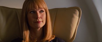 Movie still from “Iron Man 2” (2010), directed by Jon Favreau – A person sitting on a couch; Close Up shot, Over the shoulder angle