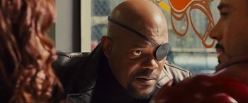 Movie still from “Iron Man 2” (2010), directed by Jon Favreau – A bald man with a eye patch is looking at the camera; Close Up shot, Over the shoulder angle