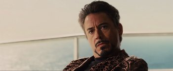 Movie still from “Iron Man 2” (2010), directed by Jon Favreau – A person with a beard; Close Up shot, Over the shoulder angle