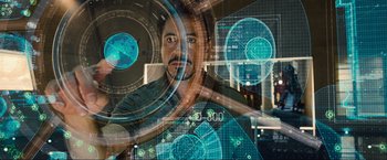 Movie still from “Iron Man 2” (2010), directed by Jon Favreau – A man is looking at a computer screen; Medium shot, Over the shoulder angle