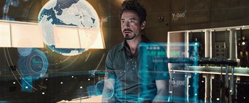 Movie still from “Iron Man 2” (2010), directed by Jon Favreau – A person in a room near a window; Medium shot, Over the shoulder angle