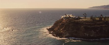 Movie still from “Iron Man 2” (2010), directed by Jon Favreau – A building on top of a cliff near the ocean; Extreme Wide shot, High angle