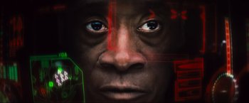 Movie still from “Iron Man 2” (2010), directed by Jon Favreau – An image of a man with red and green lines on his face; Extreme Close Up shot, Low angle