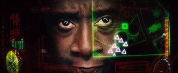 Movie still from “Iron Man 2” (2010), directed by Jon Favreau – A man's face with green lights around his face; Extreme Close Up shot, Low angle