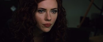 Movie still from “Iron Man 2” (2010), directed by Jon Favreau – A woman's face with red hair; Close Up shot, Over the shoulder angle