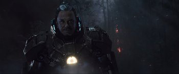 Movie still from “Iron Man 2” (2010), directed by Jon Favreau – An image of a man in a costume in the woods; Medium shot, Low angle