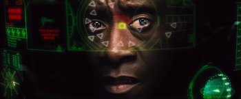 Movie still from “Iron Man 2” (2010), directed by Jon Favreau – A man's face with a green and yellow background; Extreme Close Up shot, Overhead angle