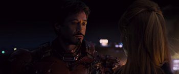 Movie still from “Iron Man 2” (2010), directed by Jon Favreau – A person wearing a suit; Close Up shot, Over the shoulder angle