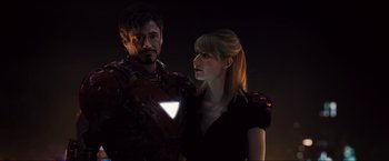 Movie still from “Iron Man 2” (2010), directed by Jon Favreau – A man and a woman standing next to each other; Close Up shot, Low angle