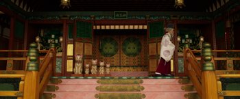 Movie still from “Isle of Dogs” (2018), directed by Wes Anderson – Many cats sitting on the steps; Wide shot, Low angle