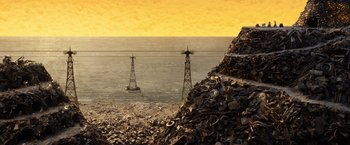 Movie still from “Isle of Dogs” (2018), directed by Wes Anderson – A pile of garbage next to the ocean with two power lines on top of it; Extreme Wide shot, Overhead angle