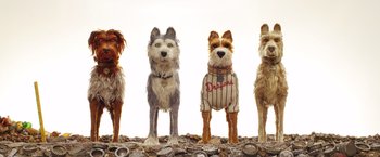 Movie still from “Isle of Dogs” (2018), directed by Wes Anderson – A group of dogs standing next to each other on rocks; Wide shot, Low angle