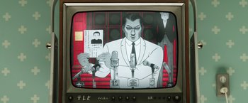 Movie still from “Isle of Dogs” (2018), directed by Wes Anderson – A television screen with a picture of a man on it; Extreme Close Up shot, Low angle