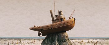 Movie still from “Isle of Dogs” (2018), directed by Wes Anderson – An image of an old rusty boat on a pile of rocks; Extreme Wide shot, Low angle